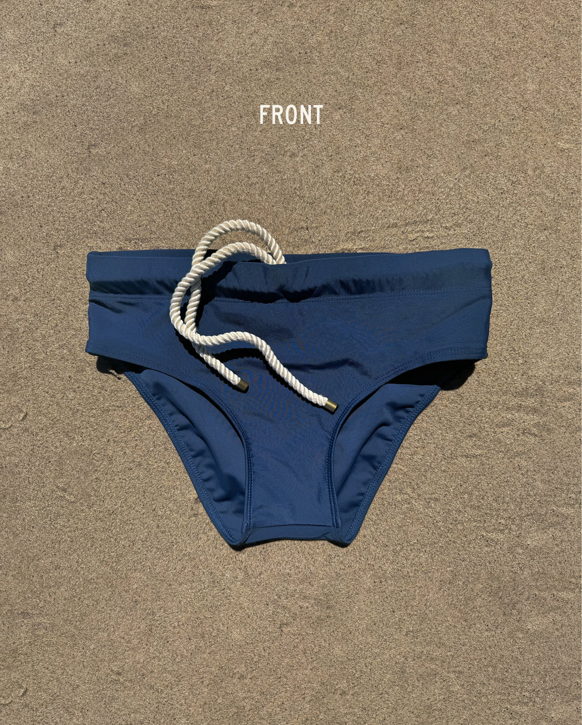 Front view of navy Lobby’s Nippers swim briefs, featuring a white rope drawstring and classic brief silhouette.