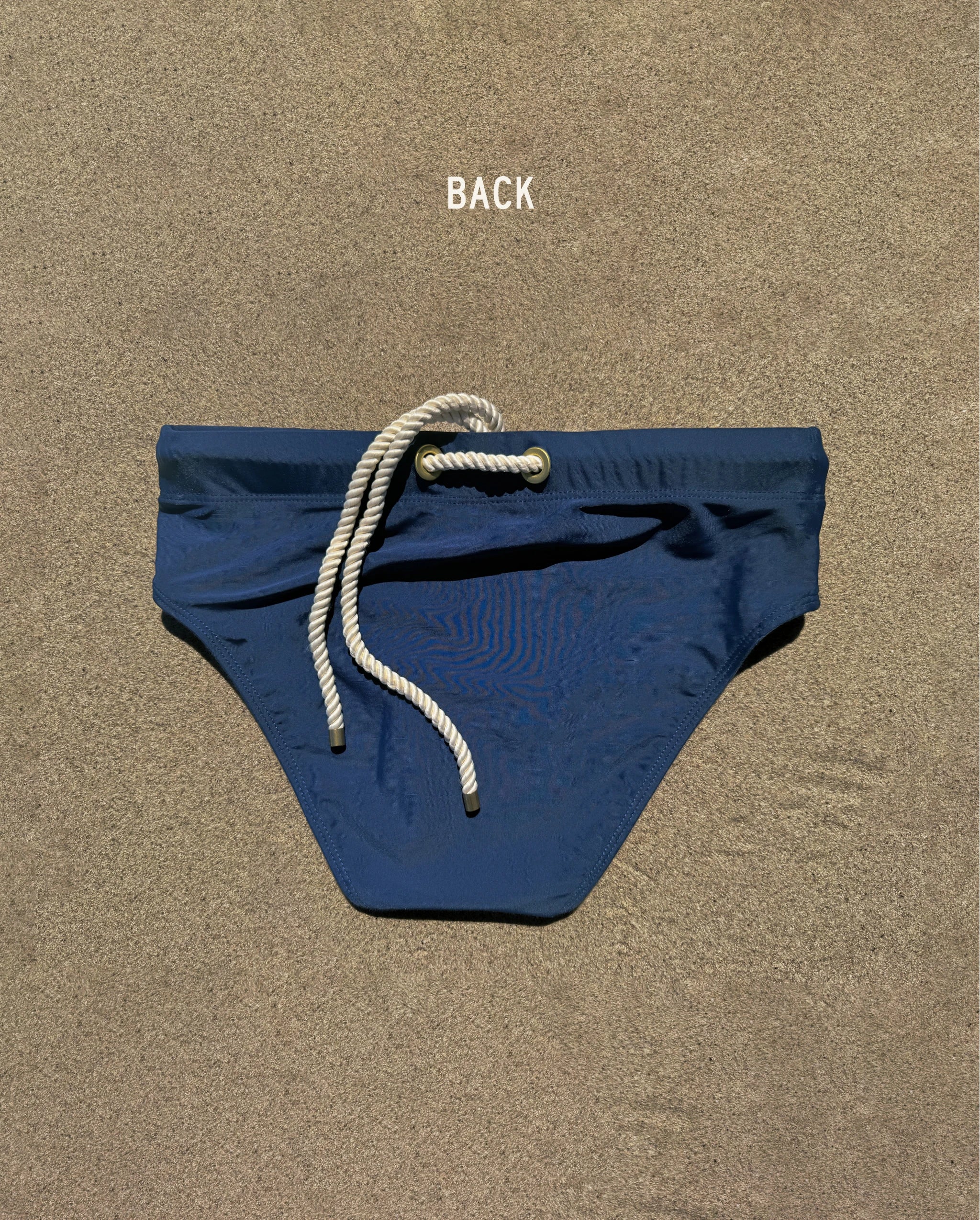 Back view of navy Lobby’s Nippers swim briefs, featuring the signature white rope detail at the waistband.