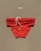 Front view of red Lobby’s Nippers swim briefs, featuring a white rope drawstring and classic brief silhouette.
