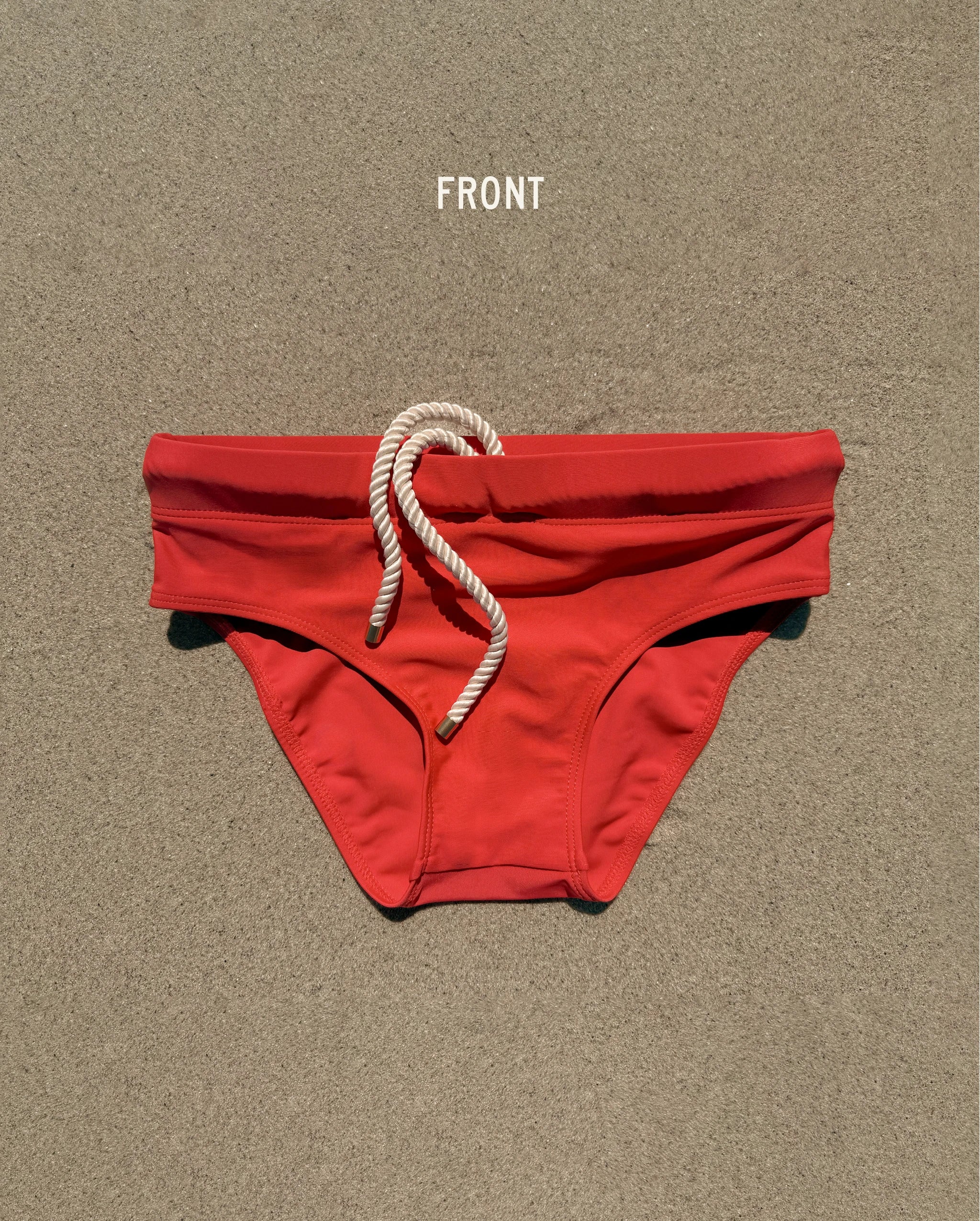 Front view of red Lobby’s Nippers swim briefs, featuring a white rope drawstring and classic brief silhouette.