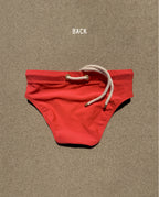 Back view of red Lobby’s Nippers swim briefs, featuring the signature white rope detail at the waistband.