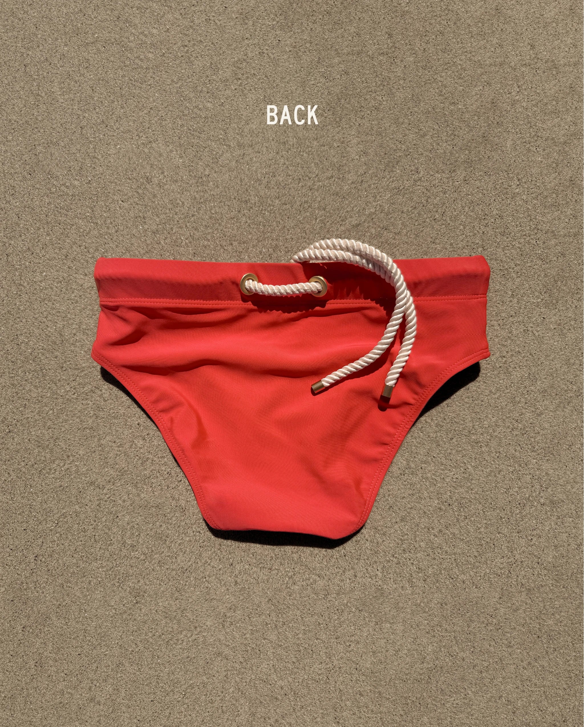 Back view of red Lobby’s Nippers swim briefs, featuring the signature white rope detail at the waistband.