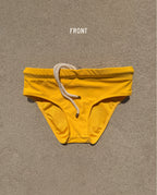 Front view of yellow Lobby’s Nippers swim briefs, featuring a white rope drawstring and classic brief silhouette.