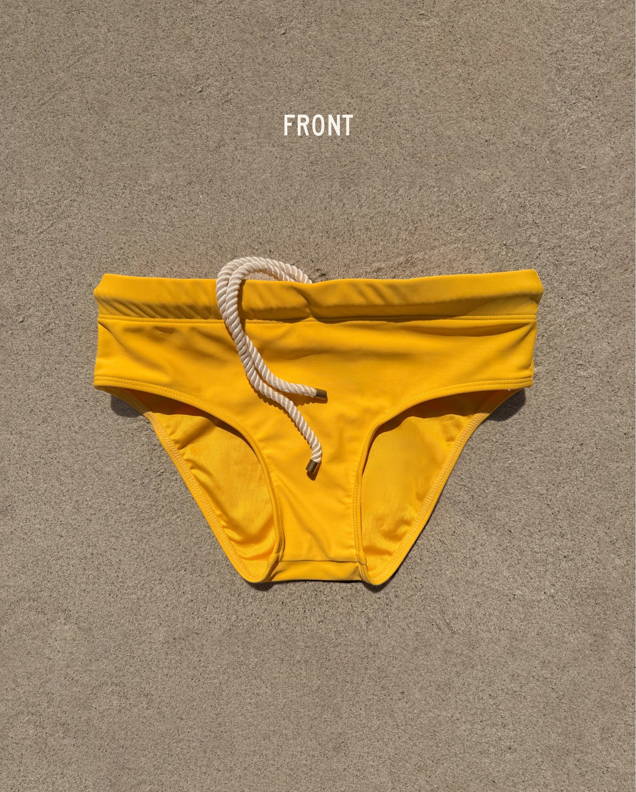 Front view of yellow Lobby’s Nippers swim briefs, featuring a white rope drawstring and classic brief silhouette.