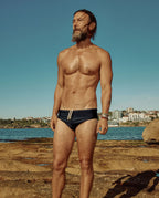 Model wearing Lobby’s black swim briefs – sleek, timeless vintage look