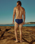Model wearing Lobby’s navy swim briefs back – classic vintage-inspired style