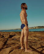Model wearing Lobby’s navy swim briefs side – classic vintage-inspired style