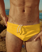 Detail shot of yellow Lobby’s swimwear on model, focusing on fabric finish and construction.